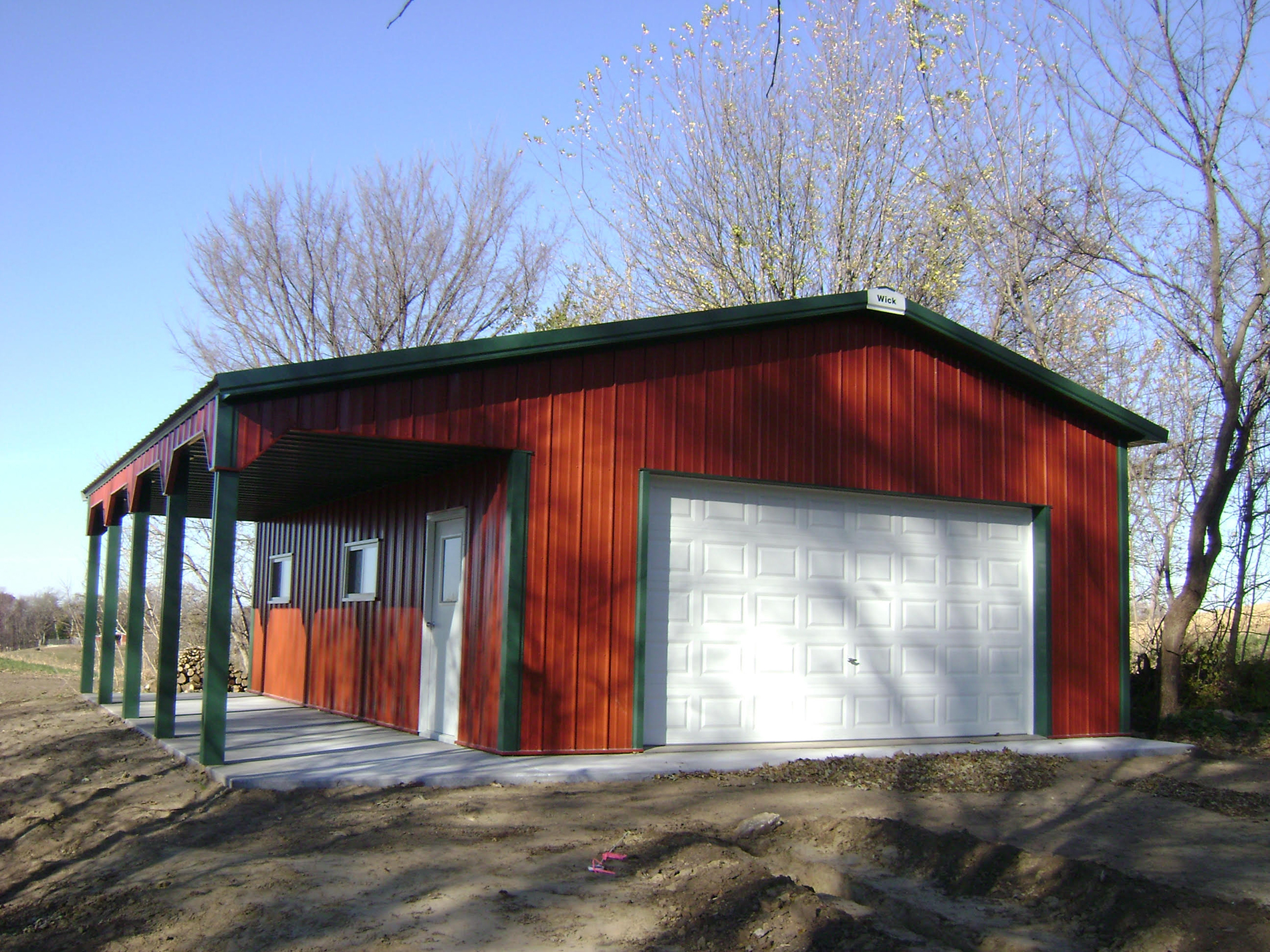 Red and white post frame suburban building