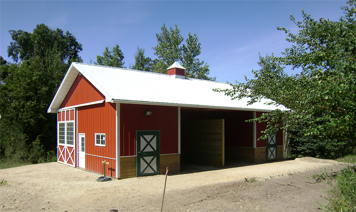 post frame construction of a red and white suburban building