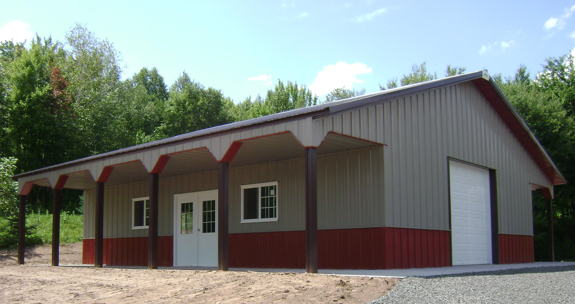 Gray and red post frame suburban building