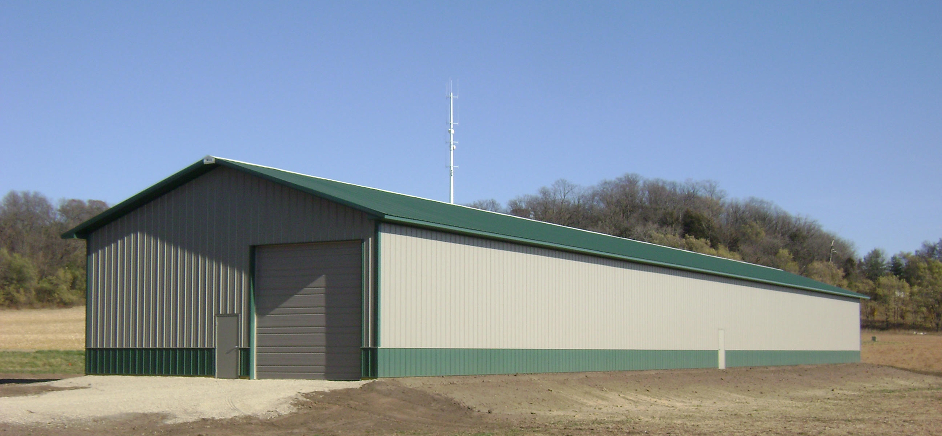 StewBer Buildings specialties include suburban storage structures such as this beige and green one