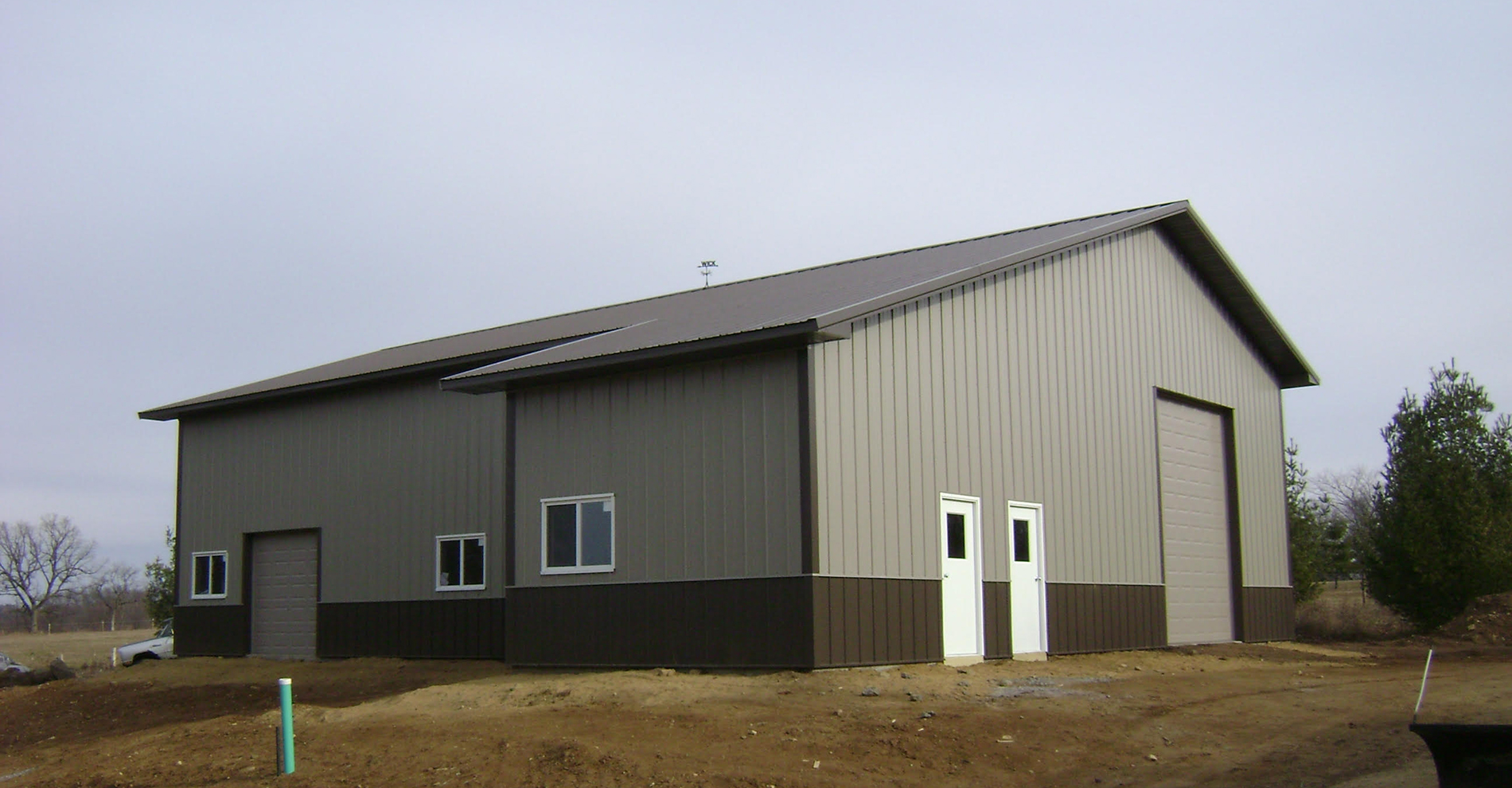 Brown and grey post frame suburban building from StewBer Buildings